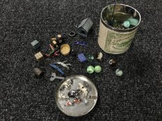 A tin of vintage marbles, gems counters, lead houses,