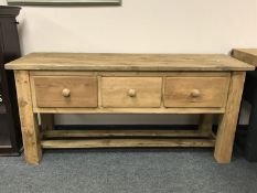 A reclaimed pine low dresser fitted with three drawers