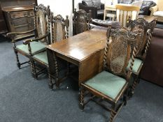 An early twentieth century oak drop leaf barley twist dining table together with a set of five