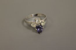A pear-cut tanzanite and three stone diamond ring