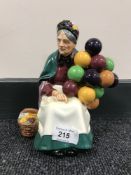 A Royal Doulton china figure : The Old Balloon Seller, HN 1315, height 20 cm.
