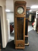 An oak cased regulator clock with silvered dial - with pendulum,