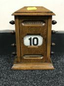 An Edwardian oak scroll calendar