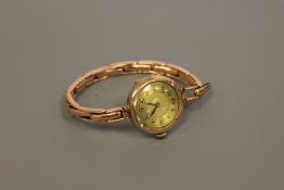 A 9ct gold lady's wristwatch upon 9ct gold bracelet
