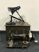 A vintage Frister and Rossmann sewing machine together with an angle poised lamp and a copper coal