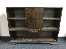 A set of continental walnut open shelves fitted with a cupboard