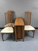A teak dropleaf storage table together with a set of three high backed Caxton chairs