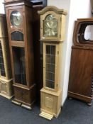 A blonde oak cased Tempis Fugit long case clock with pendulum and weights