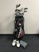 A Dunlop tour golf bag containing Dunlop irons and assorted drivers,
