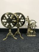 Two folding brass trivets together with a brass companion set on stand