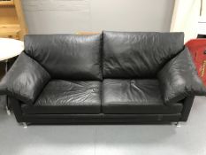 A contemporary black leather settee
