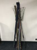 A collection of vintage fishing rods and a landing net