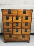A contemporary thirteen drawer metal bound ship's style chest