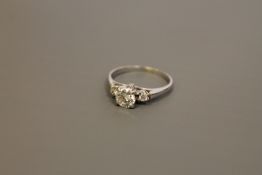 An 18ct white gold three stone diamond ring, the total diamond weight estimated at 0.