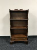 A set of mahogany open bookshelves fitted a drawer