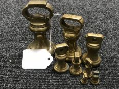 A graduated set of eight brass weights ranging from 2lbs to 1/4 oz
