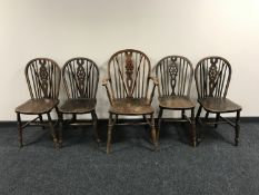 Five oak wheel back dining chairs