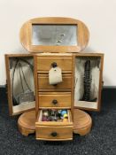 A jewellery casket containing a quantity of assorted costume jewellery including necklaces,