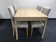 A contemporary extending dining table and four chairs