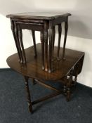 An oak dropleaf table together with a nest of three tables