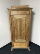 A late 19th century stripped pine side cabinet, fitted with two drawers,