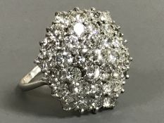 An impressive diamond cluster ring, set with thirty-seven brilliant cut stones,