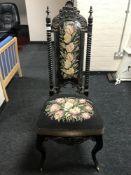 A 19th century floral tapestry side chair on cabriole legs with brass castors,