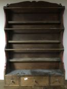 A pine plate rack fitted with three drawers below, width 76.