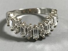 A platinum ring set with baguette and round diamonds, approximately 1ct, size N/O.