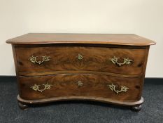 A 19th century serpentine-fronted two drawer chest, with Rococo style handles,