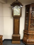 An early 19th century inlaid oak long cased clock with painted moon phase dial, height 238 cm.