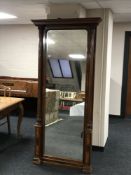 A late 19th century mahogany mirror with pillared sides, width 98 cm.