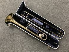 A Conn director trombone in case.
