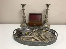 A silver plated galleried tray together with a pair of Sheffield plated candlesticks, cutlery,