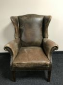 A Georgian style faded tan leather club armchair,