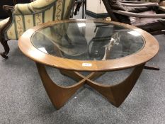 A mid 20th century teak G-Plan glass topped circular coffee table, diameter 83.5 cm.