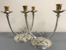 A pair of silver and silver gilt twin-branch candlesticks, C J Vander Ltd, London 1977, 1974,