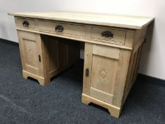 An early 20th century light oak pedestal partner's desk, fitted with six drawers, 134.