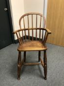 A 19th century elm child's Windsor chair, height 80 cm.
