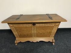 An antique style oak storage box with iron hinges,