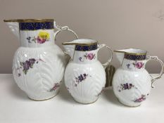 A graduated set of three Coalport gilded china jugs,