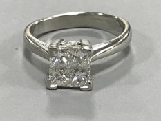 A heavy platinum ring set with four princess cut diamonds, approximately 1.0 carat total weight, 6.