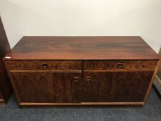 A mid 20th century rosewood low sideboard, fitted two drawers above cupboard doors below,