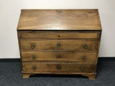 A 19th century oak bureau, with brass key escutcheons,