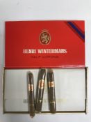 A box containing a box of twenty five half Corona cigars by Henri Wintermans.