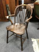 A 19th century elm wood Windsor armchair.