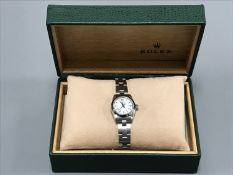 A Rolex Lady's Oyster Perpetual stainless steel wrist watch, with white dial, spare link,