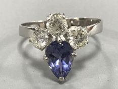 A pear-cut tanzanite and three stone diamond ring