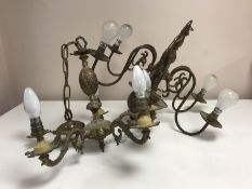 A collection of eight 20th century brass light fittings to include six-branch chandeliers,