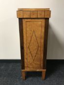 A continental inlaid walnut pillar cabinet, width 38.